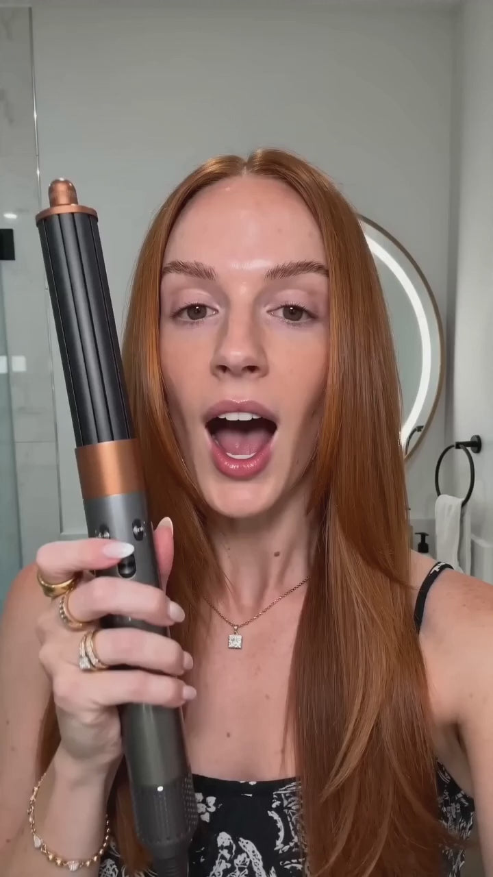 Load video: A woman uses a modern LED facial device in a softly lit
